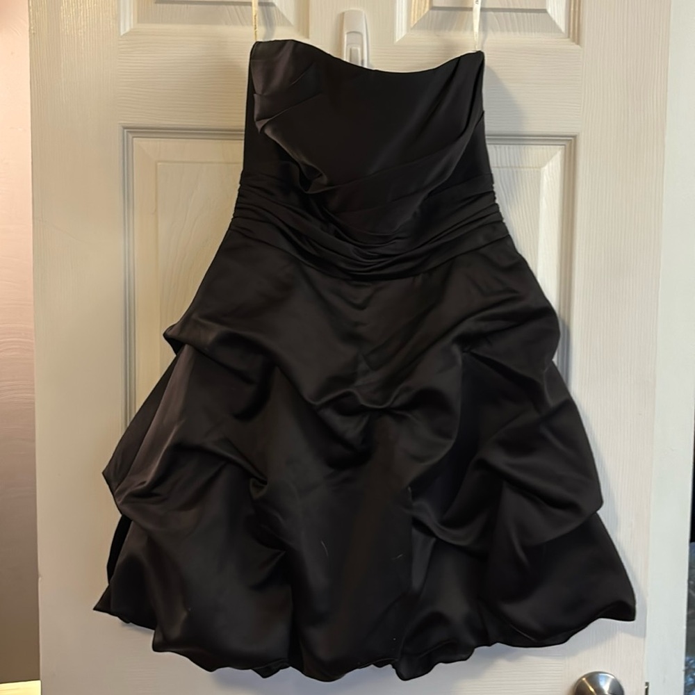 David’s bridal.  Strapless short black satin dress.